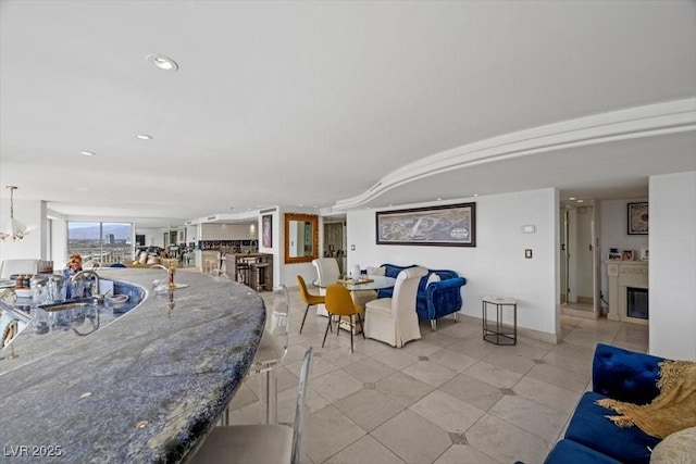 3111 Bel Air Dr Unit 21A & 21C, Las Vegas, NV 89109 - dining space with a glass covered fireplace and recessed lighting