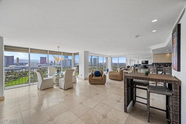3111 Bel Air Dr Unit 21A & 21C, Las Vegas, NV 89109 - living room with a wall of windows, a view of skyline, and light tile patterned flooring