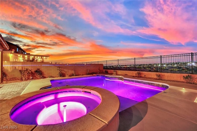 2714 Frabiele St, Henderson, NV 89044 - pool at dusk with a fenced backyard, a patio area, and a pool with connected hot tub