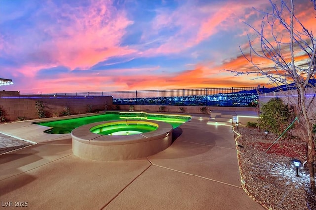 2714 Frabiele St, Henderson, NV 89044 - pool at dusk featuring a fenced backyard, a patio area, and a pool with connected hot tub