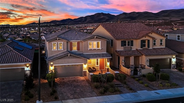 2714 Frabiele St, Henderson, NV 89044 - view of front of home with stucco siding, a mountain view, decorative driveway, an attached garage, and a tiled roof