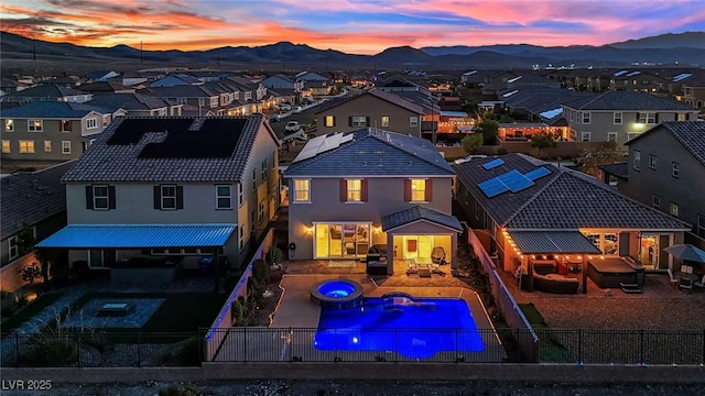 2714 Frabiele St, Henderson, NV 89044 - back of property featuring a fenced backyard, a residential view, a mountain view, and a pool with connected hot tub