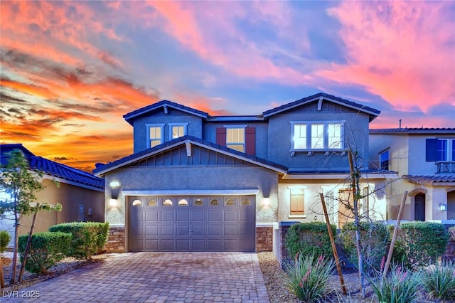 2714 Frabiele St, Henderson, NV 89044 - view of front facade with decorative driveway, stone siding, a garage, and stucco siding