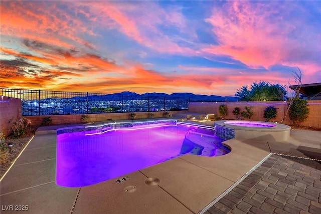 2714 Frabiele St, Henderson, NV 89044 - pool at dusk featuring a fenced backyard, a mountain view, a patio area, and a pool with connected hot tub
