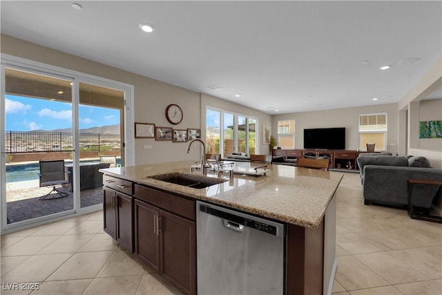 2714 Frabiele St, Henderson, NV 89044 - kitchen featuring stainless steel dishwasher, light tile patterned floors, light stone countertops, dark brown cabinets, and open floor plan