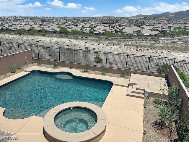 2714 Frabiele St, Henderson, NV 89044 - view of swimming pool with a fenced backyard, a residential view, a pool with connected hot tub, and a mountain view