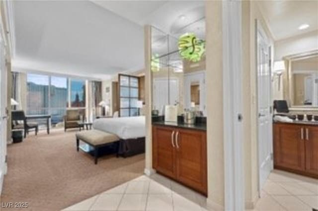 135 E Harmon Ave Unit 407, Las Vegas, NV 89109 - bedroom featuring light tile patterned floors and light colored carpet