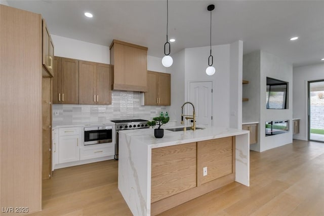 10452 Niagara Falls Ln, Las Vegas, NV 89144 - kitchen featuring stainless steel appliances, light wood finished floors, decorative backsplash, light stone counters, and pendant lighting