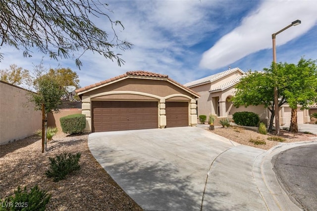 10452 Niagara Falls Ln, Las Vegas, NV 89144 - mediterranean / spanish house featuring stucco siding, driveway, an attached garage, and a tiled roof