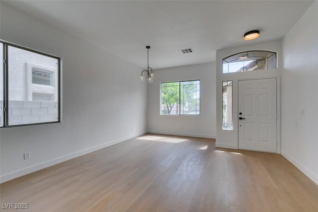 10452 Niagara Falls Ln, Las Vegas, NV 89144 - entrance foyer featuring light wood-style flooring and a chandelier