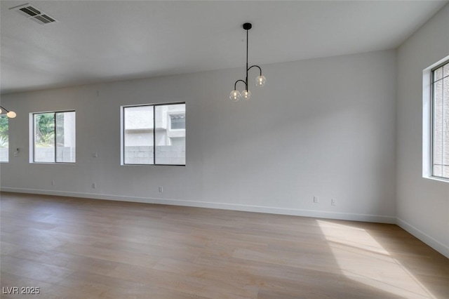 10452 Niagara Falls Ln, Las Vegas, NV 89144 - spare room featuring a chandelier and light wood-style floors