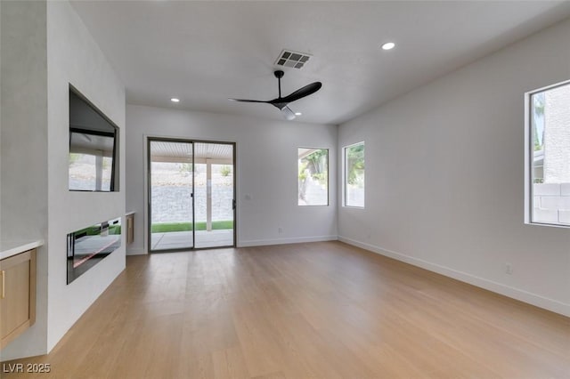 10452 Niagara Falls Ln, Las Vegas, NV 89144 - unfurnished living room with ceiling fan, light wood-style flooring, and recessed lighting