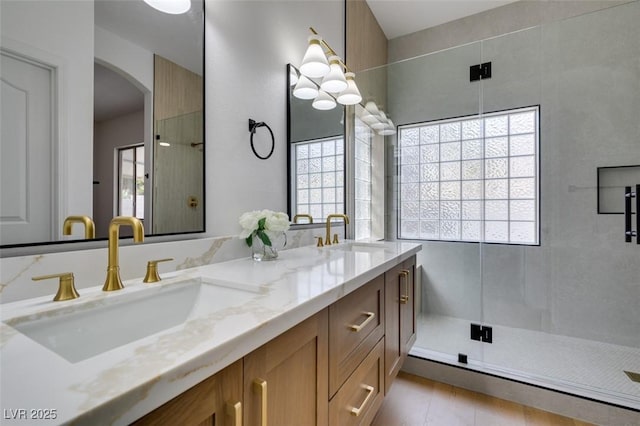 10452 Niagara Falls Ln, Las Vegas, NV 89144 - bathroom featuring double vanity, a shower stall, and healthy amount of natural light