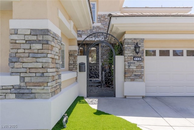 712 Proud Eagle Ln, Las Vegas, NV 89144 - property entrance with stucco siding, a garage, stone siding, and driveway
