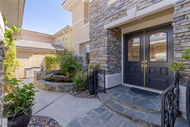 712 Proud Eagle Ln, Las Vegas, NV 89144 - entrance to property featuring french doors, stone siding, and stucco siding