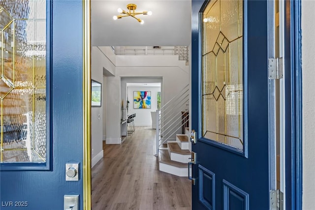 712 Proud Eagle Ln, Las Vegas, NV 89144 - foyer entrance with stairway, wood finished floors, and a chandelier