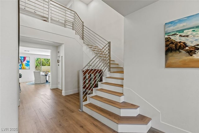 712 Proud Eagle Ln, Las Vegas, NV 89144 - staircase featuring wood finished floors and a towering ceiling