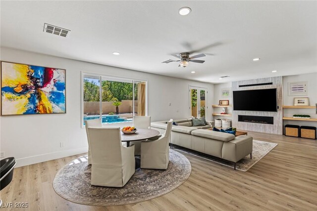 712 Proud Eagle Ln, Las Vegas, NV 89144 - living area featuring healthy amount of natural light, a ceiling fan, recessed lighting, light wood-style flooring, and a fireplace
