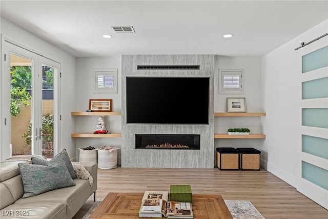 712 Proud Eagle Ln, Las Vegas, NV 89144 - living room with a fireplace, recessed lighting, and wood finished floors
