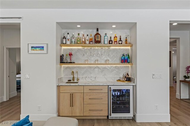 712 Proud Eagle Ln, Las Vegas, NV 89144 - indoor wet bar featuring wine cooler, light wood-style flooring, backsplash, and recessed lighting