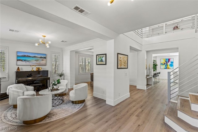 712 Proud Eagle Ln, Las Vegas, NV 89144 - living room featuring light wood finished floors, stairs, and a chandelier