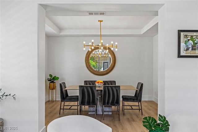 712 Proud Eagle Ln, Las Vegas, NV 89144 - dining room featuring a chandelier, a raised ceiling, and wood finished floors