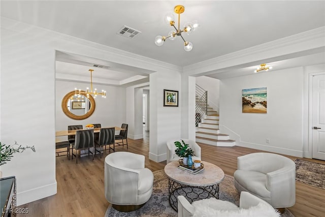 712 Proud Eagle Ln, Las Vegas, NV 89144 - living room with a chandelier, stairway, light wood finished floors, and ornamental molding