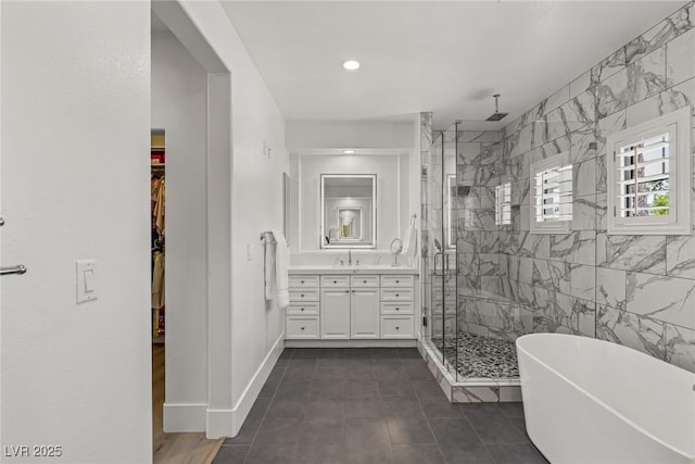712 Proud Eagle Ln, Las Vegas, NV 89144 - full bathroom with a shower stall, vanity, a soaking tub, a walk in closet, and tile patterned flooring
