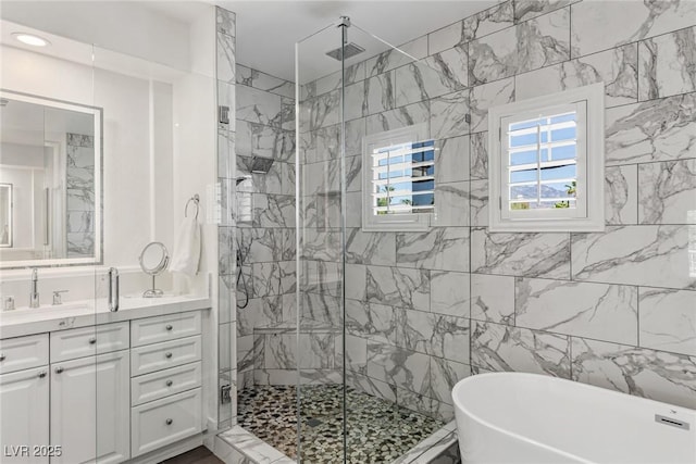 712 Proud Eagle Ln, Las Vegas, NV 89144 - bathroom featuring a freestanding tub, a shower stall, vanity, and tile walls
