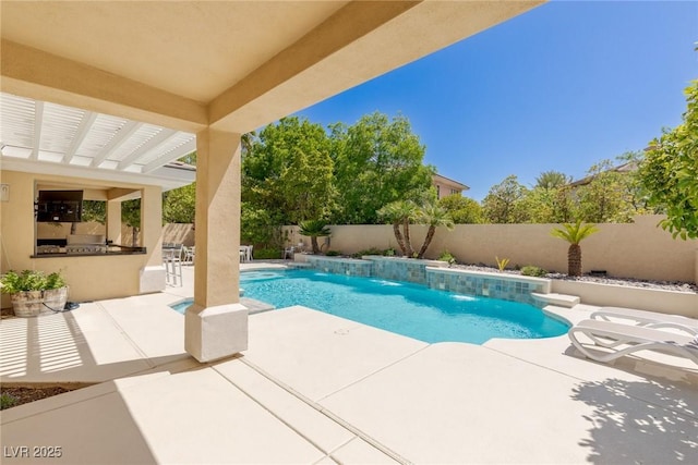 712 Proud Eagle Ln, Las Vegas, NV 89144 - view of swimming pool featuring exterior kitchen, a fenced backyard, and a patio area