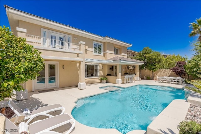 712 Proud Eagle Ln, Las Vegas, NV 89144 - back of house with a balcony, stucco siding, a patio, french doors, and outdoor dining space