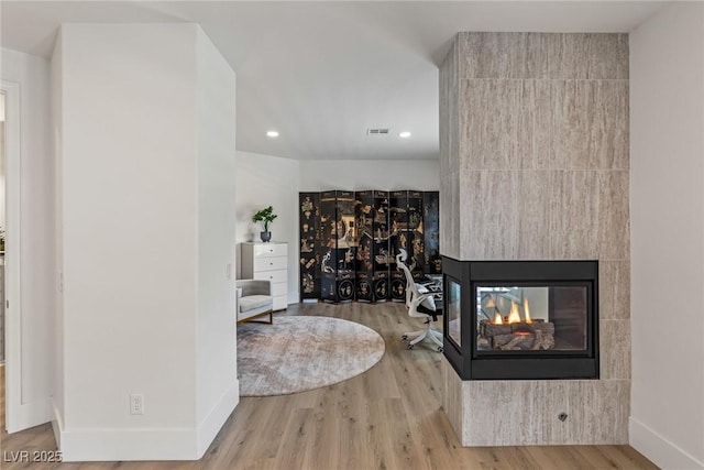712 Proud Eagle Ln, Las Vegas, NV 89144 - living area featuring wood finished floors, recessed lighting, and a multi sided fireplace