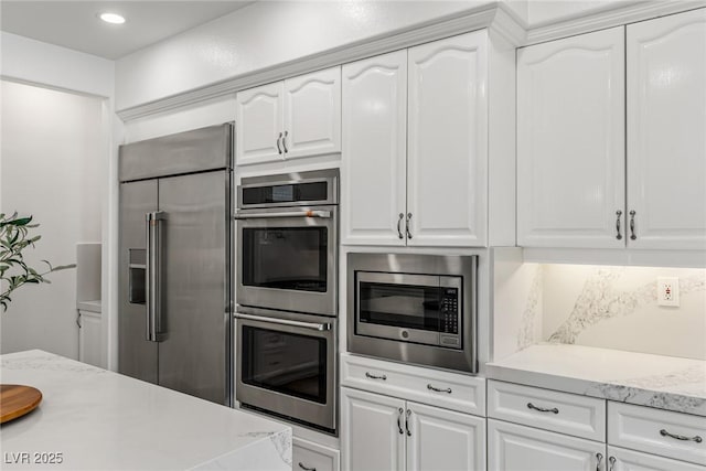 712 Proud Eagle Ln, Las Vegas, NV 89144 - kitchen featuring built in appliances, white cabinets, and recessed lighting