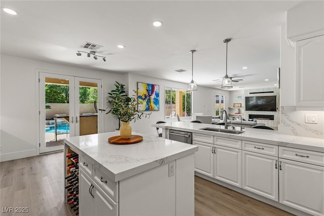 712 Proud Eagle Ln, Las Vegas, NV 89144 - kitchen with ceiling fan, recessed lighting, healthy amount of natural light, white cabinetry, and a peninsula