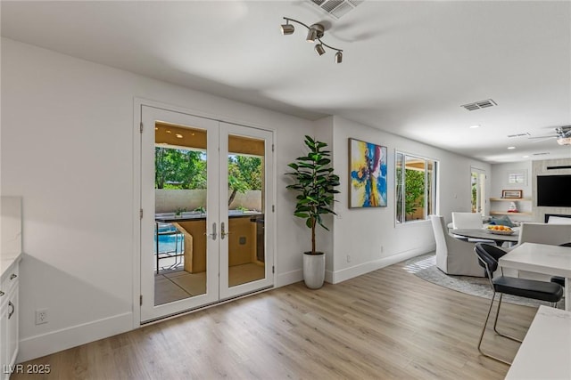 712 Proud Eagle Ln, Las Vegas, NV 89144 - living area with french doors, light wood-style floors, and ceiling fan