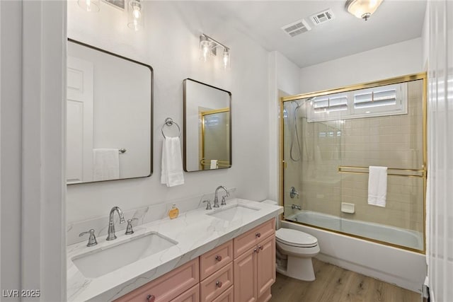 712 Proud Eagle Ln, Las Vegas, NV 89144 - full bath with double vanity, wood finished floors, and bath / shower combo with glass door