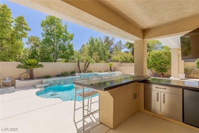712 Proud Eagle Ln, Las Vegas, NV 89144 - view of pool featuring a fenced backyard, exterior kitchen, and a patio
