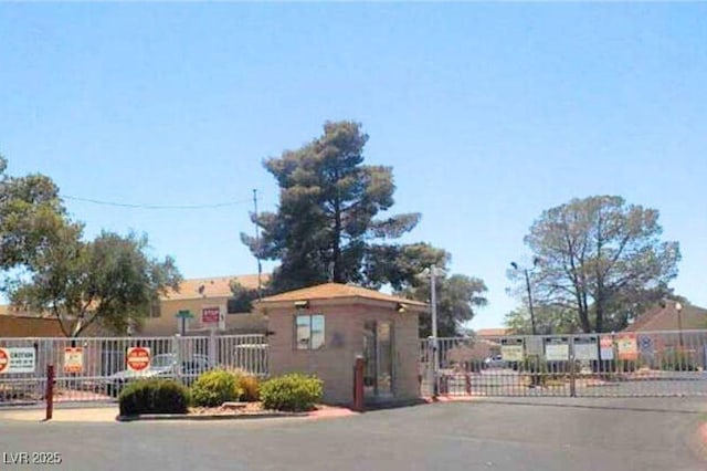 5155 Gray Ln, Las Vegas, NV 89119 - view of asphalt road with a gated entry and a gate