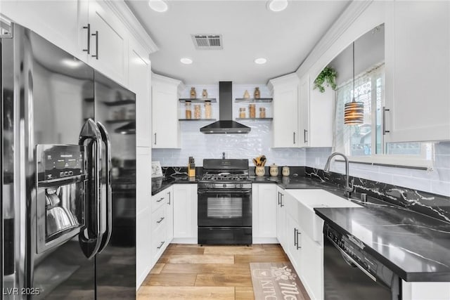 6536 Pleasant Plains Way, Las Vegas, NV 89108 - kitchen with black appliances, wall chimney range hood, white cabinets, light wood-style floors, and open shelves