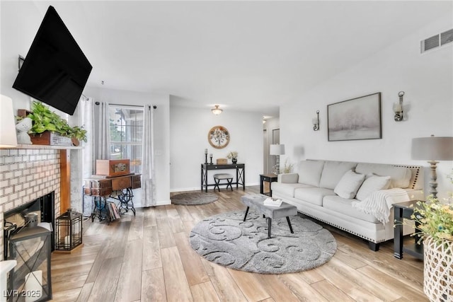 6536 Pleasant Plains Way, Las Vegas, NV 89108 - living area featuring wood finished floors and a brick fireplace
