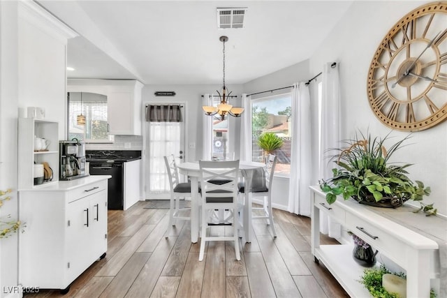6536 Pleasant Plains Way, Las Vegas, NV 89108 - dining space with a chandelier, light wood-style floors, and healthy amount of natural light