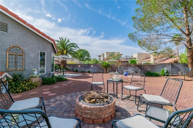 6536 Pleasant Plains Way, Las Vegas, NV 89108 - fenced backyard featuring an outdoor fire pit and a patio area