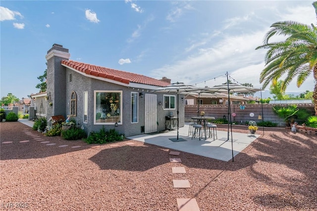 6536 Pleasant Plains Way, Las Vegas, NV 89108 - back of house with a chimney, stucco siding, a tile roof, and a patio