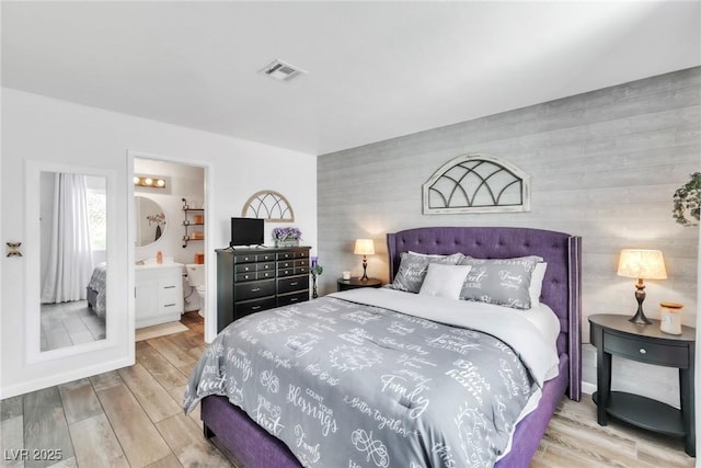 6536 Pleasant Plains Way, Las Vegas, NV 89108 - bedroom with an accent wall and wood finished floors