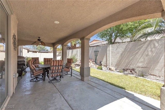 4408 Oasis Plains Ave, North Las Vegas, NV 89085 - fenced backyard with outdoor dining area, a patio, and a ceiling fan