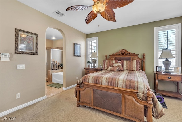 4408 Oasis Plains Ave, North Las Vegas, NV 89085 - bedroom with arched walkways, light carpet, ensuite bathroom, and a ceiling fan