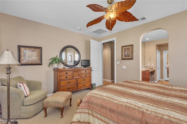 4408 Oasis Plains Ave, North Las Vegas, NV 89085 - carpeted bedroom featuring arched walkways, a ceiling fan, and ensuite bath