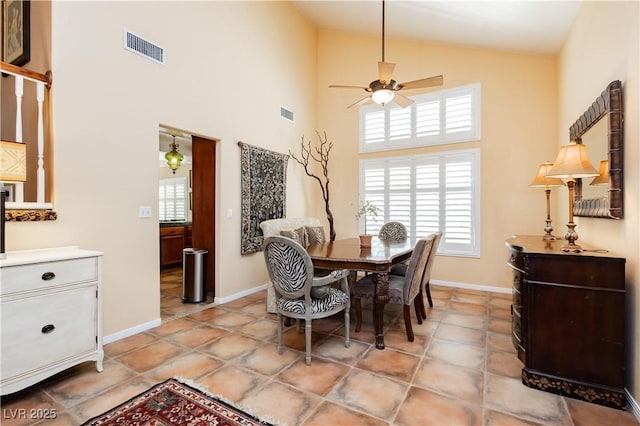 8875 Tidal Bay Dr, Las Vegas, NV 89117 - dining room featuring high vaulted ceiling, ceiling fan, healthy amount of natural light, and light tile patterned flooring