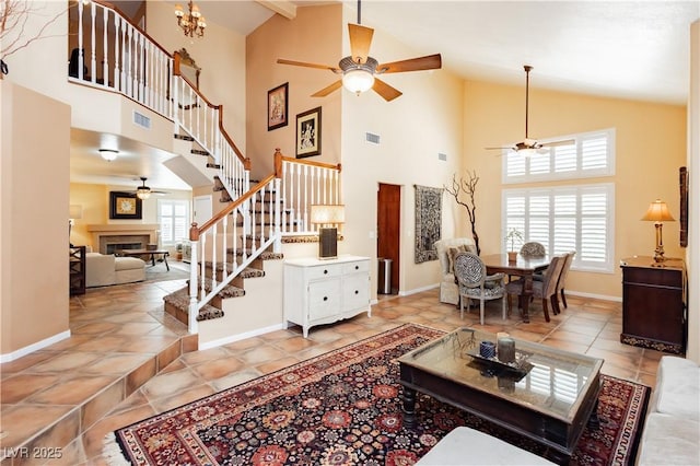 8875 Tidal Bay Dr, Las Vegas, NV 89117 - living area featuring a ceiling fan, a fireplace, stairs, and high vaulted ceiling