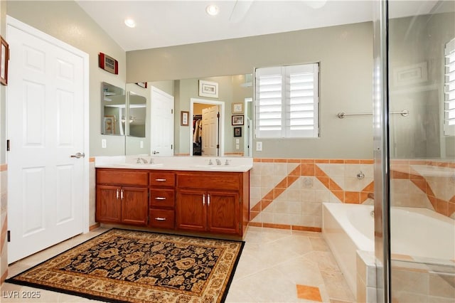 8875 Tidal Bay Dr, Las Vegas, NV 89117 - full bath featuring tile patterned flooring, a bath, double vanity, a shower with shower door, and tile walls